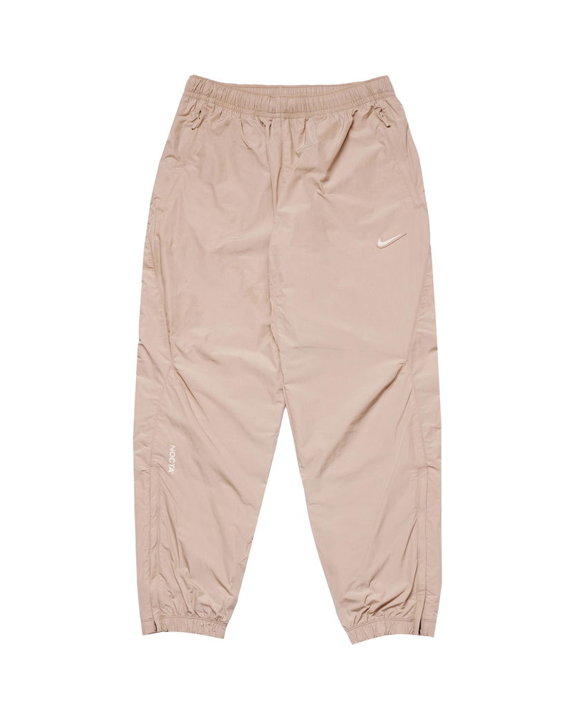 Nohavice Nike x NOCTA NRG CS WOVEN TRACK PANT Béžová | FN7668-200