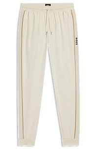 Cotton-terry tracksuit bottoms with side tape and vertical logo