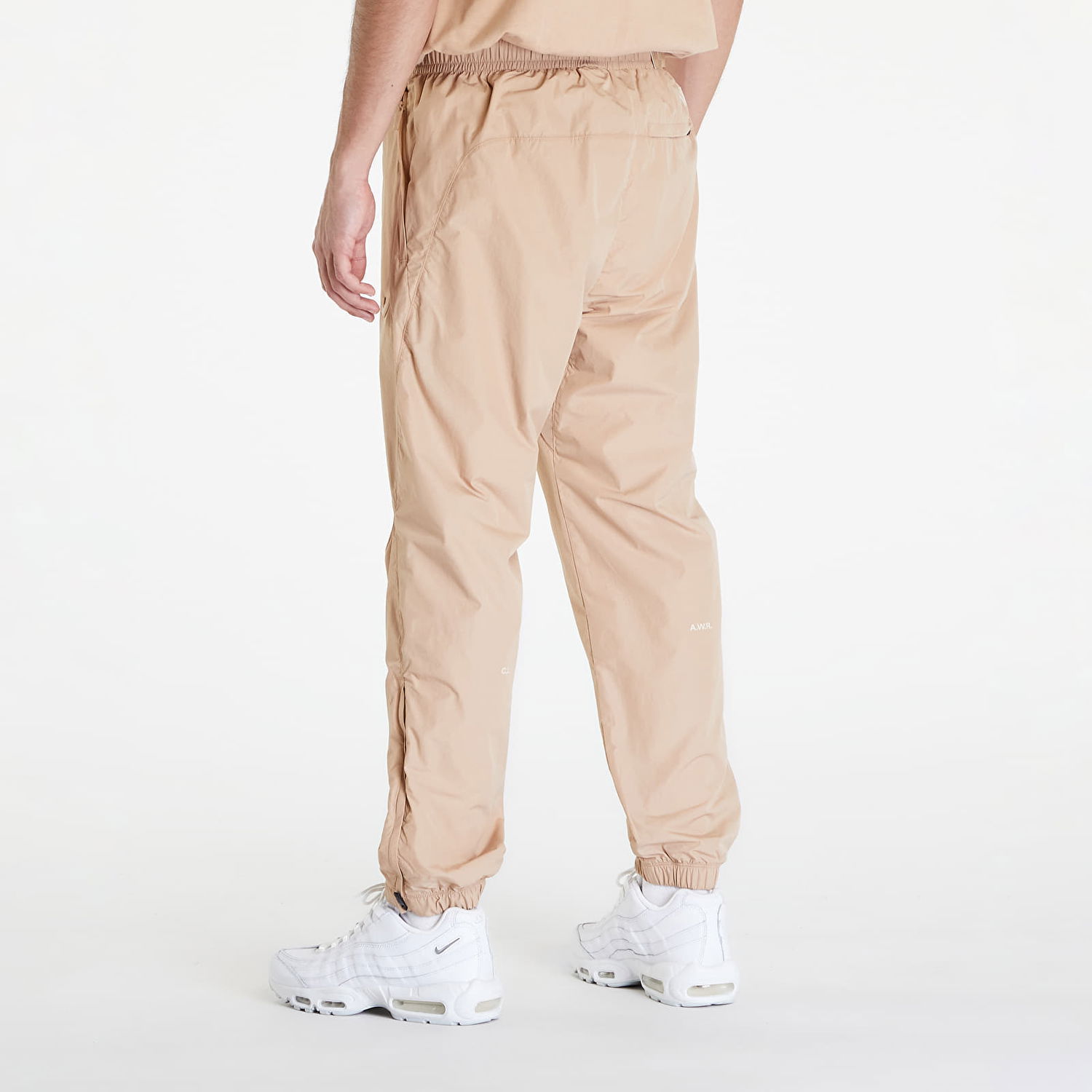 Nohavice Nike x NOCTA NRG CS WOVEN TRACK PANT Béžová | FN7668-200, 1