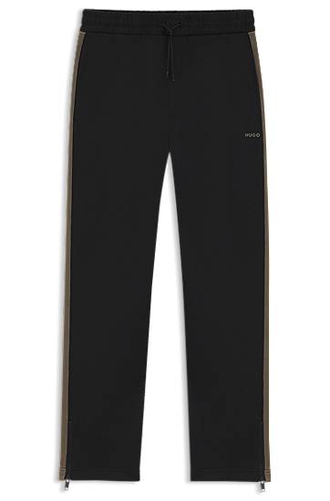 Tepláky BOSS Relaxed-fit tracksuit bottoms with logo tape and ankle zippers Čierna | 50551351